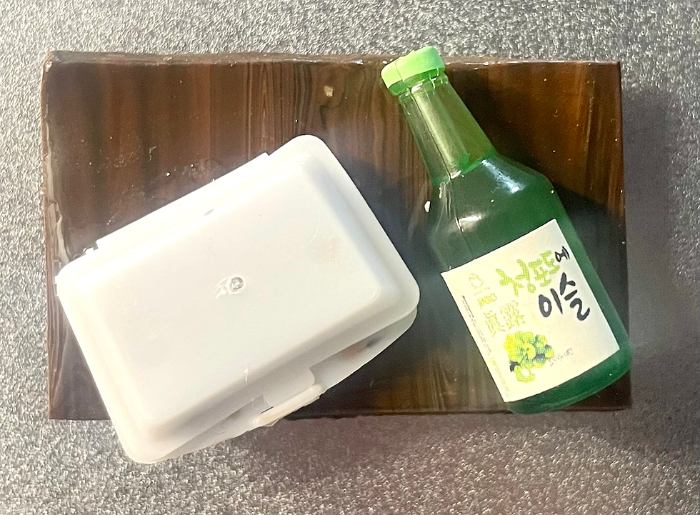 fridge magnet of Japanese braised pork belly with scallions in a white takeout container and a sake bottle