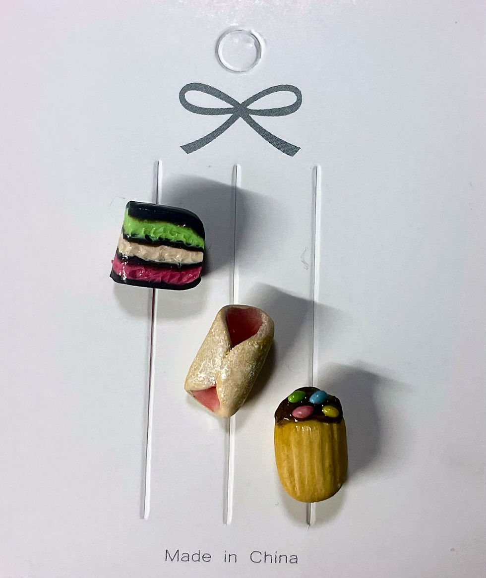 lapel and backpack pins of Italian butter cookies with red jelly filling and chocolate filling and a rainbow cookie