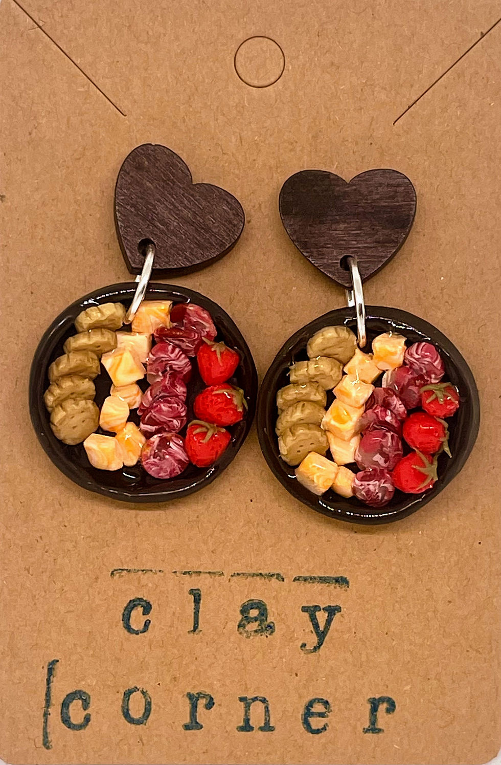 heart drop earrings of crackers and cheese cubes and salami slices and strawberries