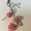 Thumbnail: phone charm of starbucks pink drink with strawberries and ice and pink cake pops, one with a bite mark