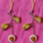 lapel pins of a fried bologna sandwich with lettuce sliced in half and a side of baked beans in a white bowl