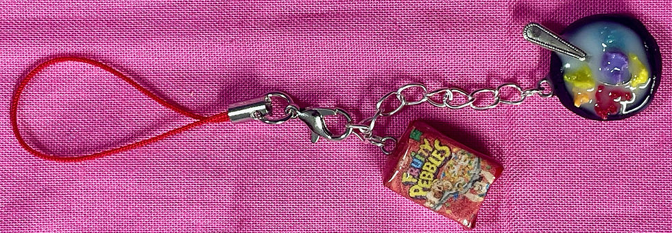 Thumbnail: phone charm of a fruity pebbles cereal box and a bowl of cereal with a tiny spoon  in it
