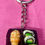 Thumbnail: keychain of a black bento box with edamame and 2 sushi rolls and a shrimp sashimi