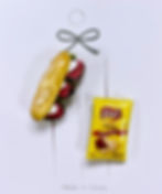 pins of a deli reuben sandwich with roast beef and mozzarella cheese on italian bread hero with a bag of lays potato chips