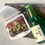 Thumbnail: fridge magnet of Japanese braised pork belly with scallions in a white takeout container and a sake bottle