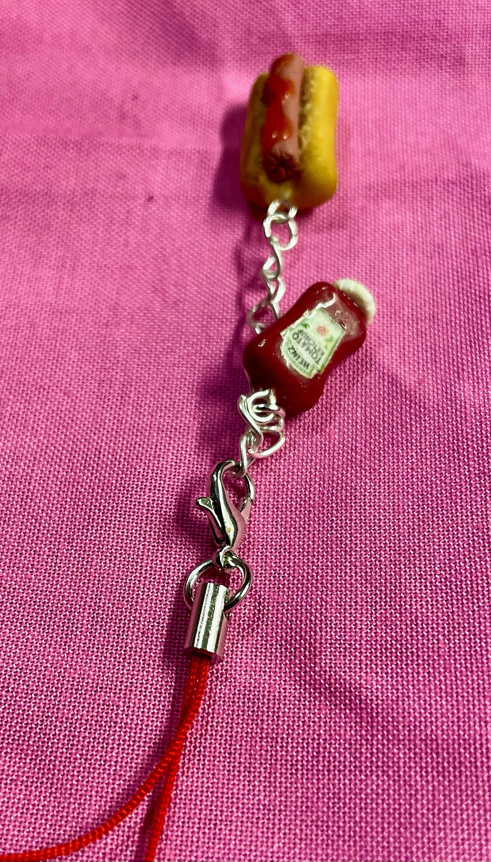 Thumbnail: phone case charms of a heinz ketchup bottle and a hotdog with ketchup