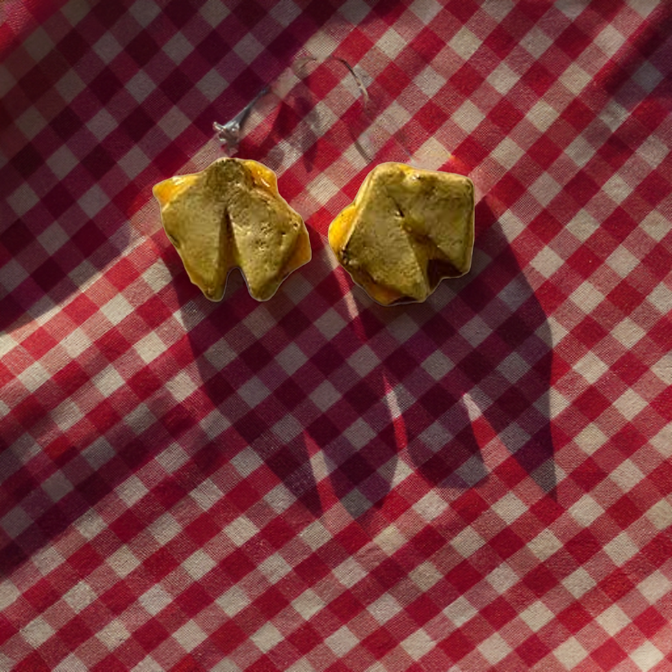 stud food earrings of a grilled cheese sandwich that’s sliced and cheese is melting in the middle