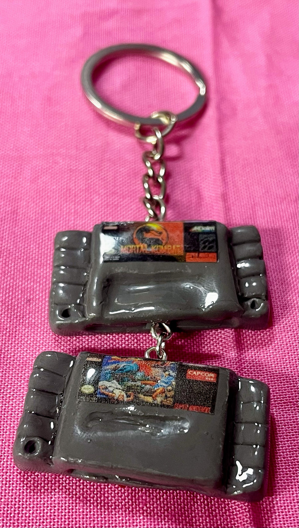 Thumbnail: keychain of super nintendo snes game cartridges of street fighter II and mortal kombat