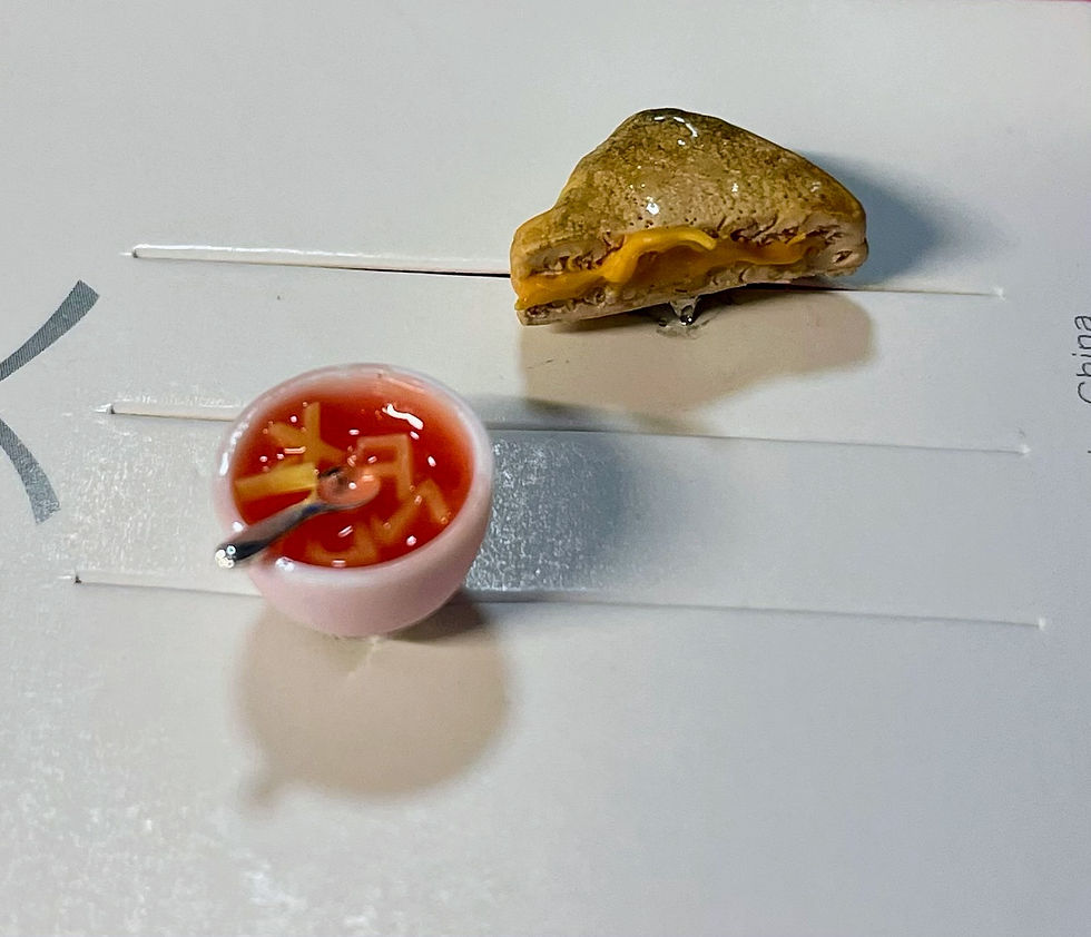 Thumbnail: lapel pins of red alphabet soup with tiny spoons with grilled cheese slices and melted cheese