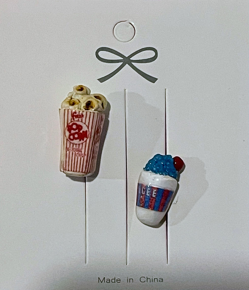 pin of popcorn in a red and white striped popcorn box with a blueberry icee slushee