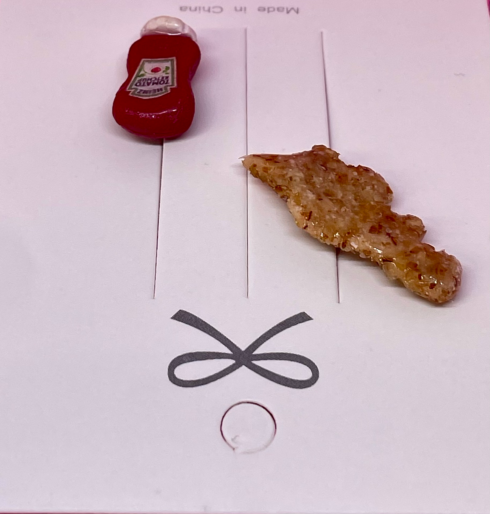 Thumbnail: Pin of a dinosaur chicken nugget and a pin of a heinz bottle of ketchup