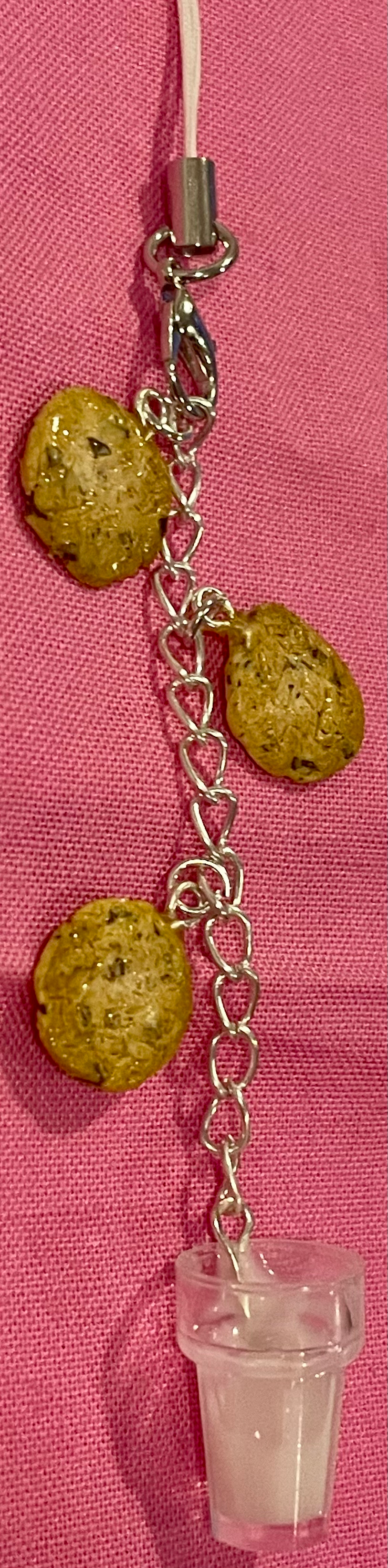 Thumbnail: phone charm of three chocolate chip cookies and a glass of milk