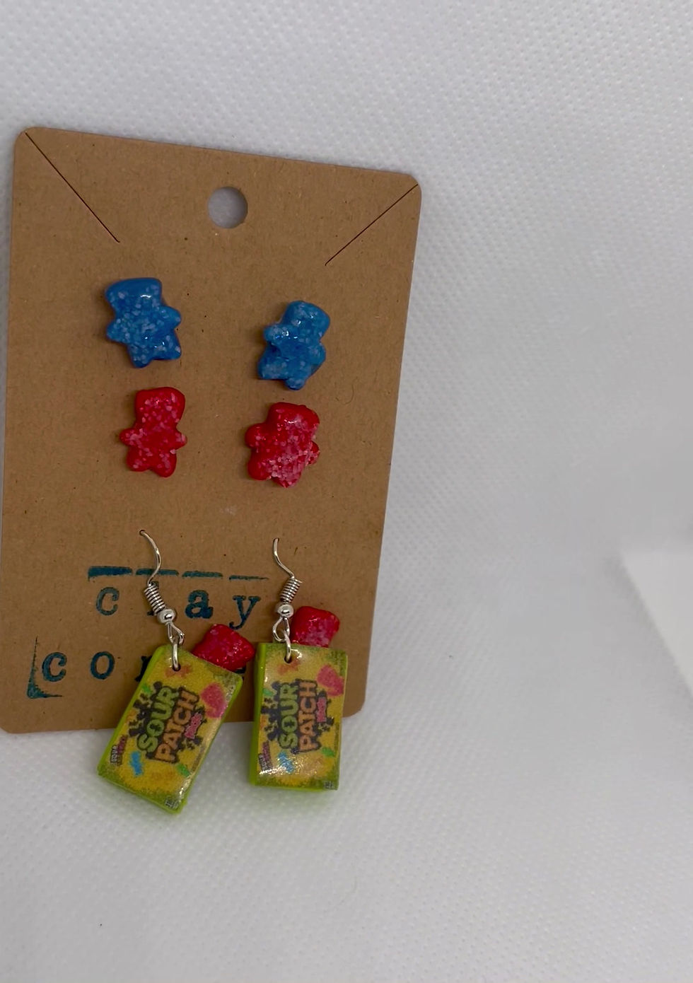 dangle earrings of sour patch kids candy box with a candy and a red sour patch kid candy and a blue sour patch kids studs