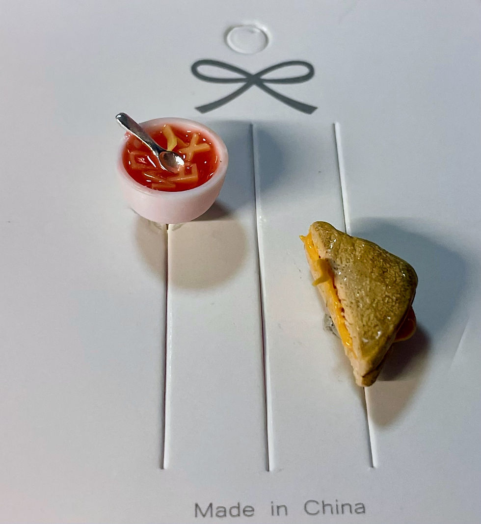 lapel pins of red alphabet soup with tiny spoons with grilled cheese slices and melted cheese