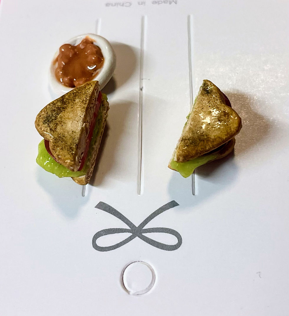 Thumbnail: lapel pins of a fried bologna sandwich with lettuce sliced in half and a side of baked beans in a white bowl