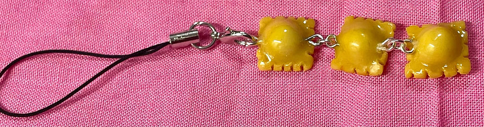 Thumbnail: phone charm of three cooked yellow raviolis hanging from each other