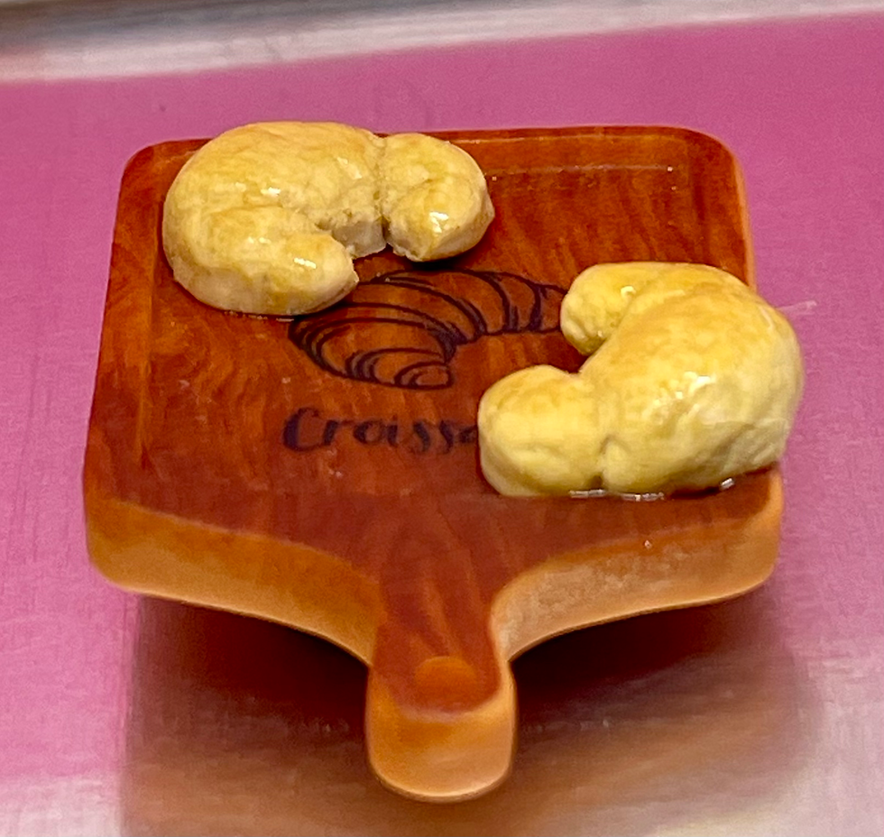 Fridge Food Magnet of Freshly baked croissants on a wooden cutting board