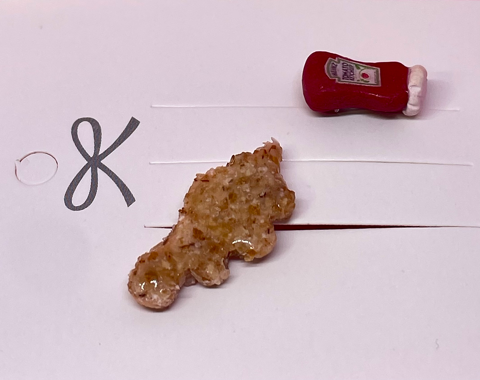 Pin of a dinosaur chicken nugget and a pin of a heinz bottle of ketchup