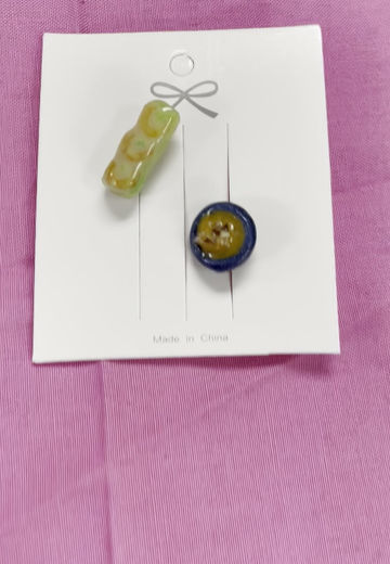 Thumbnail: Pins of a shrimp spring roll  and a peanut sauce dip with real nuts in a blue dipping bowl
