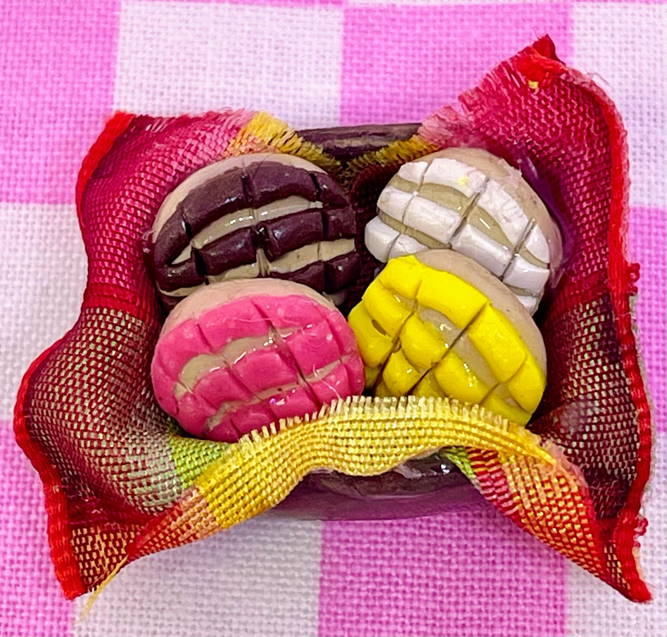 Food Fridge Magnet of Mexican conchas bread pastries wrapped in a colorful cloth in a wooden basket