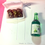 Thumbnail: pins of Japanese braised pork belly with scallions in a white takeout container and a sake bottle