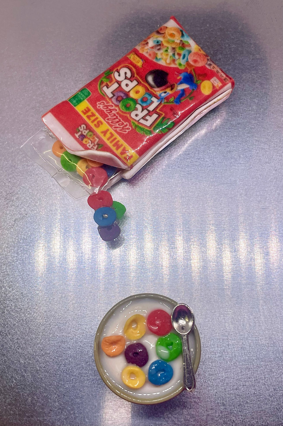magnet of froot loops in a cereal box being poured into a bowl of froot loops cereal and milk