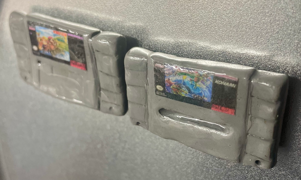 magnets of super nintendo snes game cartridges of donkey kong country 3 and teenage mutant ninja turtles