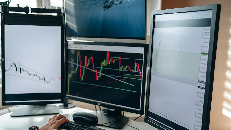 A multi-monitor stock trading setup showcasing charts and data analysis in a home office setting.