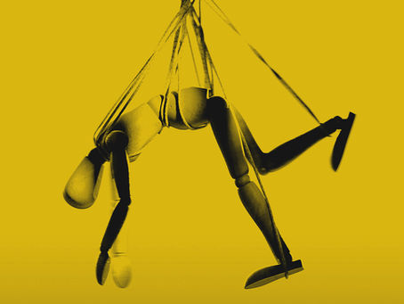 A wooden doll, hanging.