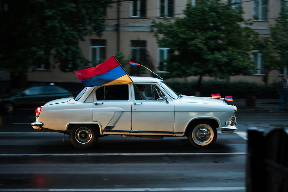 A car carrying Armenian flag. Photo by Rafael Ishkhanyan on Unsplash