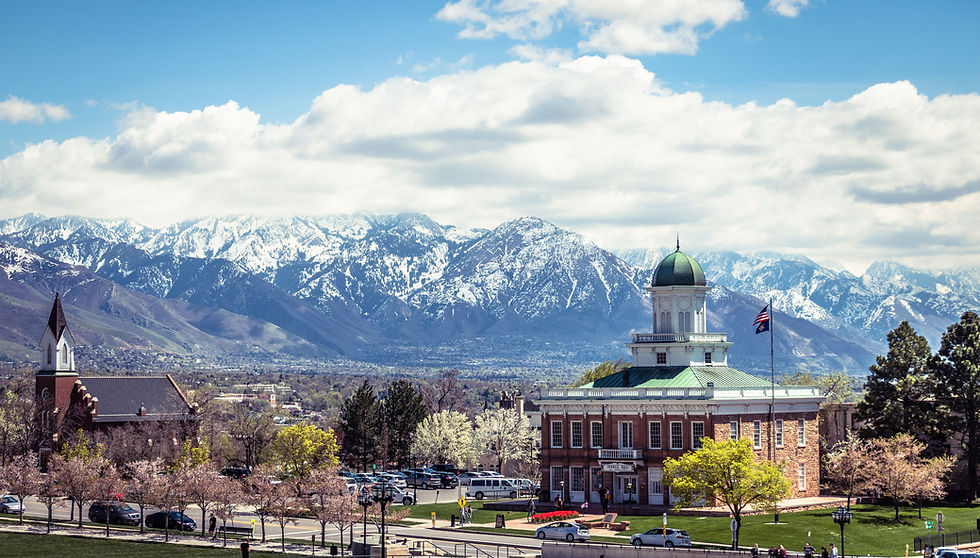 A picturesque view of Salt Lake City's historic buildings against the snow-capped mountain