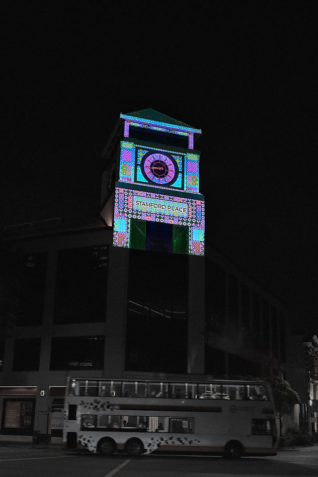 Stamford Road clock tower illuminated with colourful patterns during the Singapore Night Festival