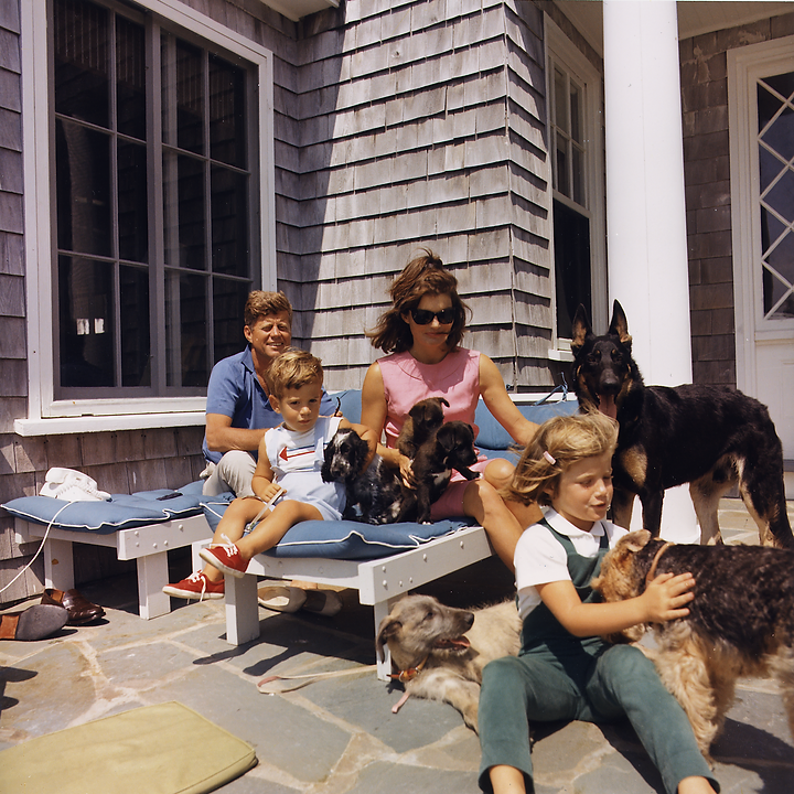 The Kennedy Family sitting outside with their children and pet dogs