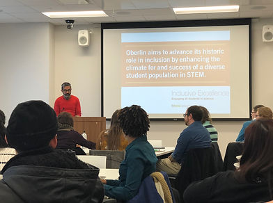 A man gives a presentation to a group of faculty and staff about Inclusive Excellence at Oberlin College.