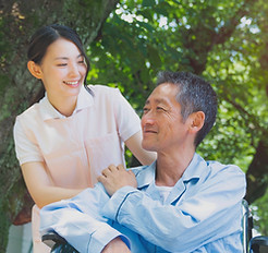 Senior Patient In Wheelchair And Caregiv