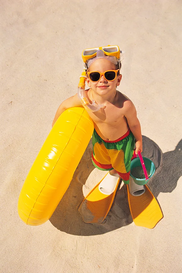 kid on the beach in the summer