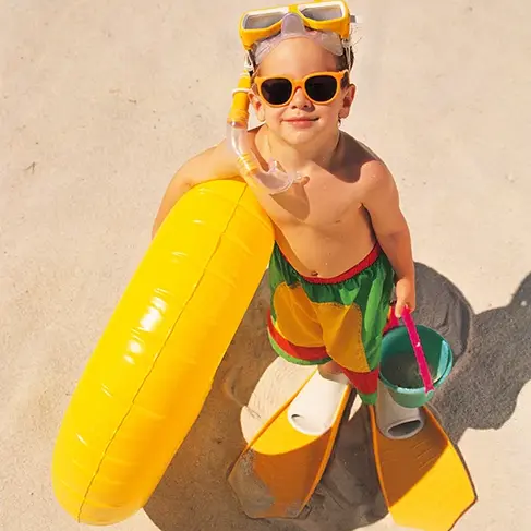 kid on the beach in the summer
