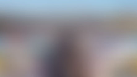 Vibrant panoramic view of the Foire Internationale de Marseille 2025, showcasing diverse exhibition pavilions, bustling crowds, and a festive atmosphere with flags.