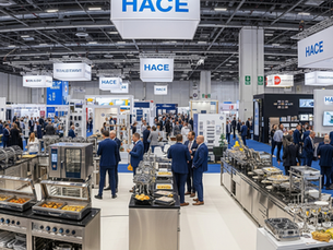 Wide view of HACE Hotel Expo 2026, showcasing various hotel supplies, catering equipment, and hospitality professionals networking at booths.