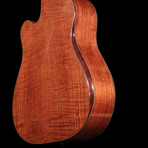 Back of acoustic guitar showing beautiful curly Claro Walnut wood grain.