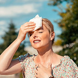 Woman wearing a t-shirt experiencing a h