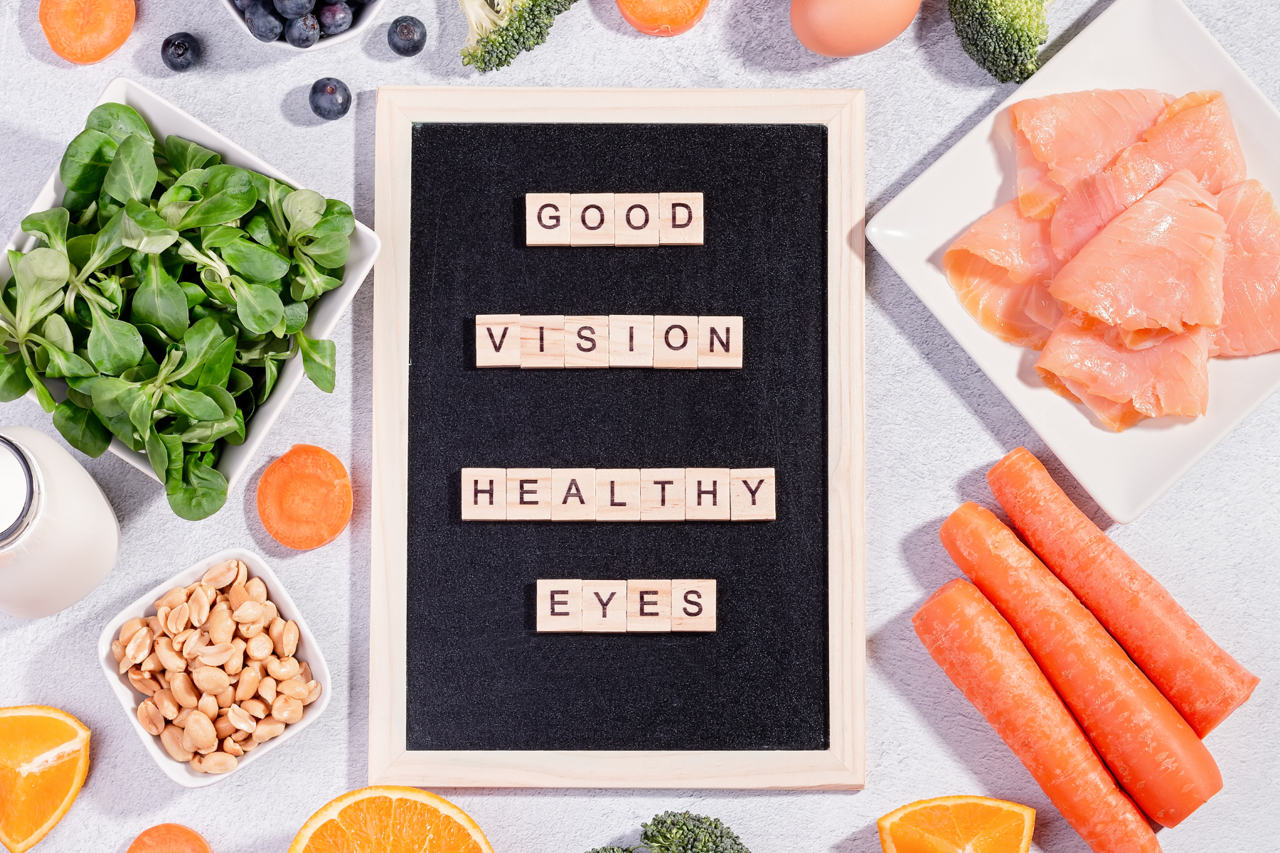 foods for healthy eye sight and vision displayed carrots, eggs, spinach, oranges and more