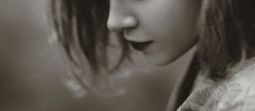 A sad woman looking down.