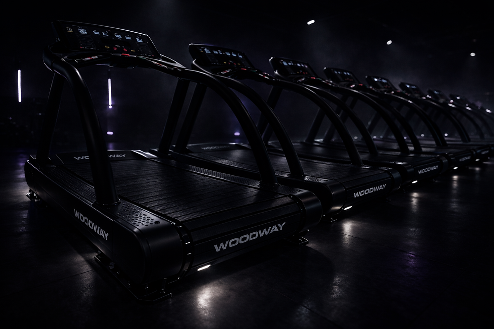 Sleek treadmills in a dimly lit gym.png