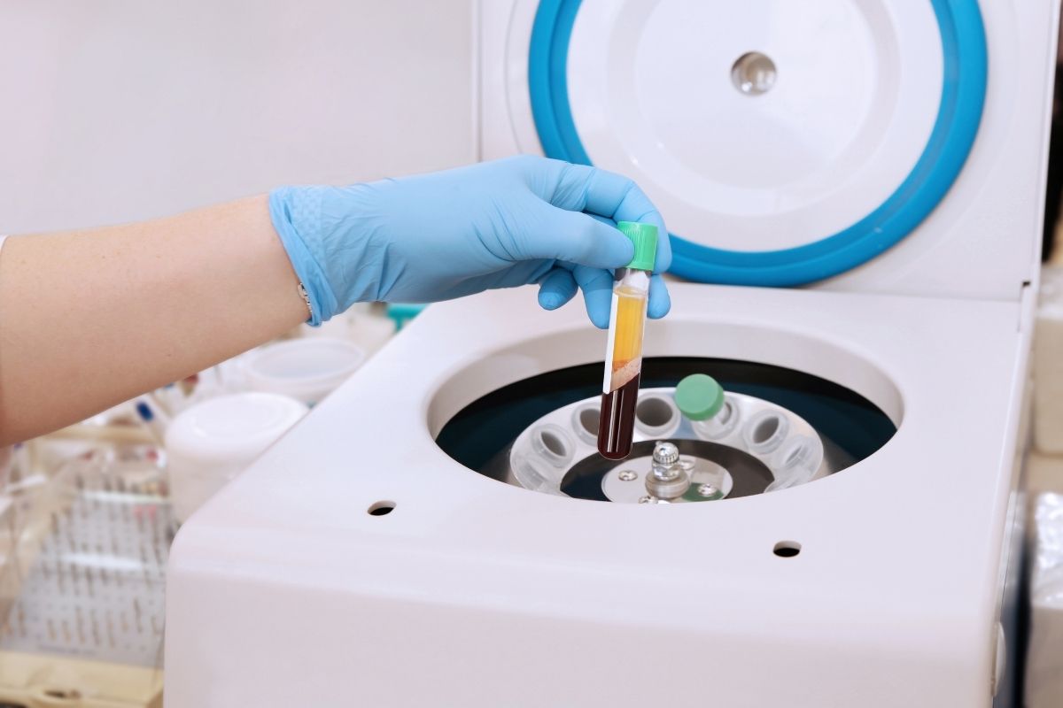 Medical professional extracting platelet-rich plasma for a Vampire Facial treatment.