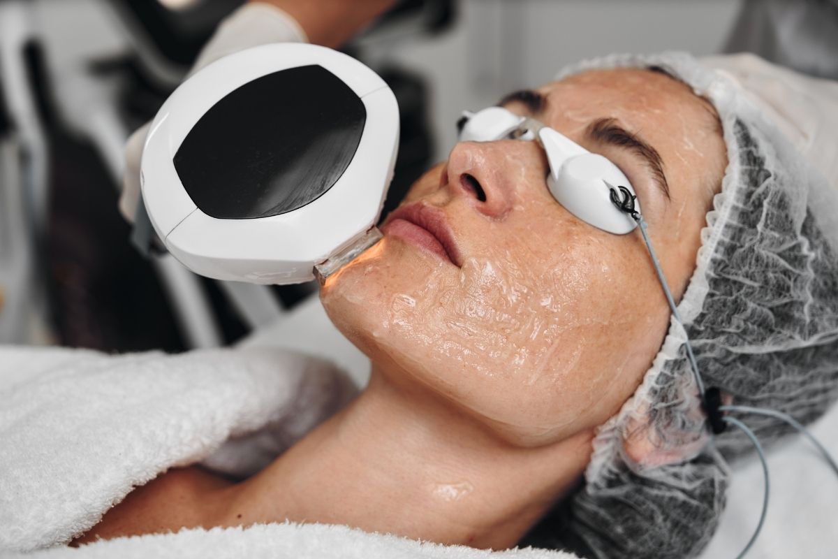 A person receiving an IPL treatment for skin rejuvenation in a professional spa setting.