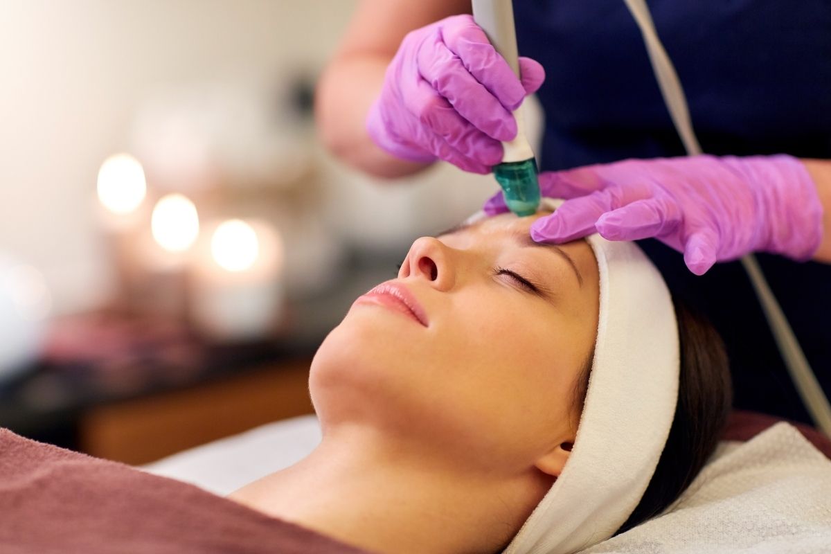 Woman enjoying a facial as part of a customized skincare package in Noida.