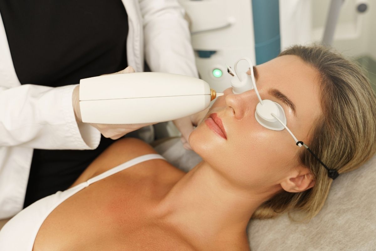 Light-emitting IPL device applied to a client’s face during a Photo Facial session.