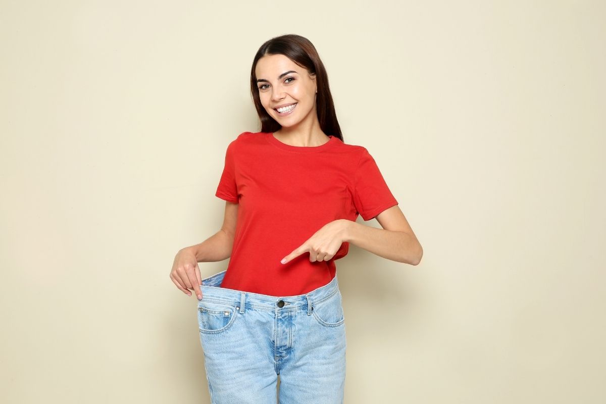 Happy client after achieving fat reduction results with cavitation therapy.