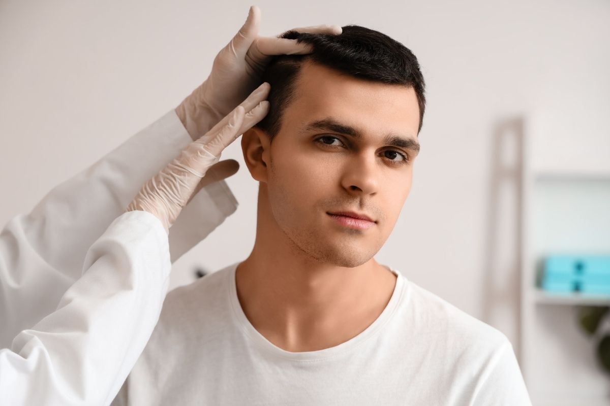 A client consulting with a specialist about IV drip therapy for hair growth.